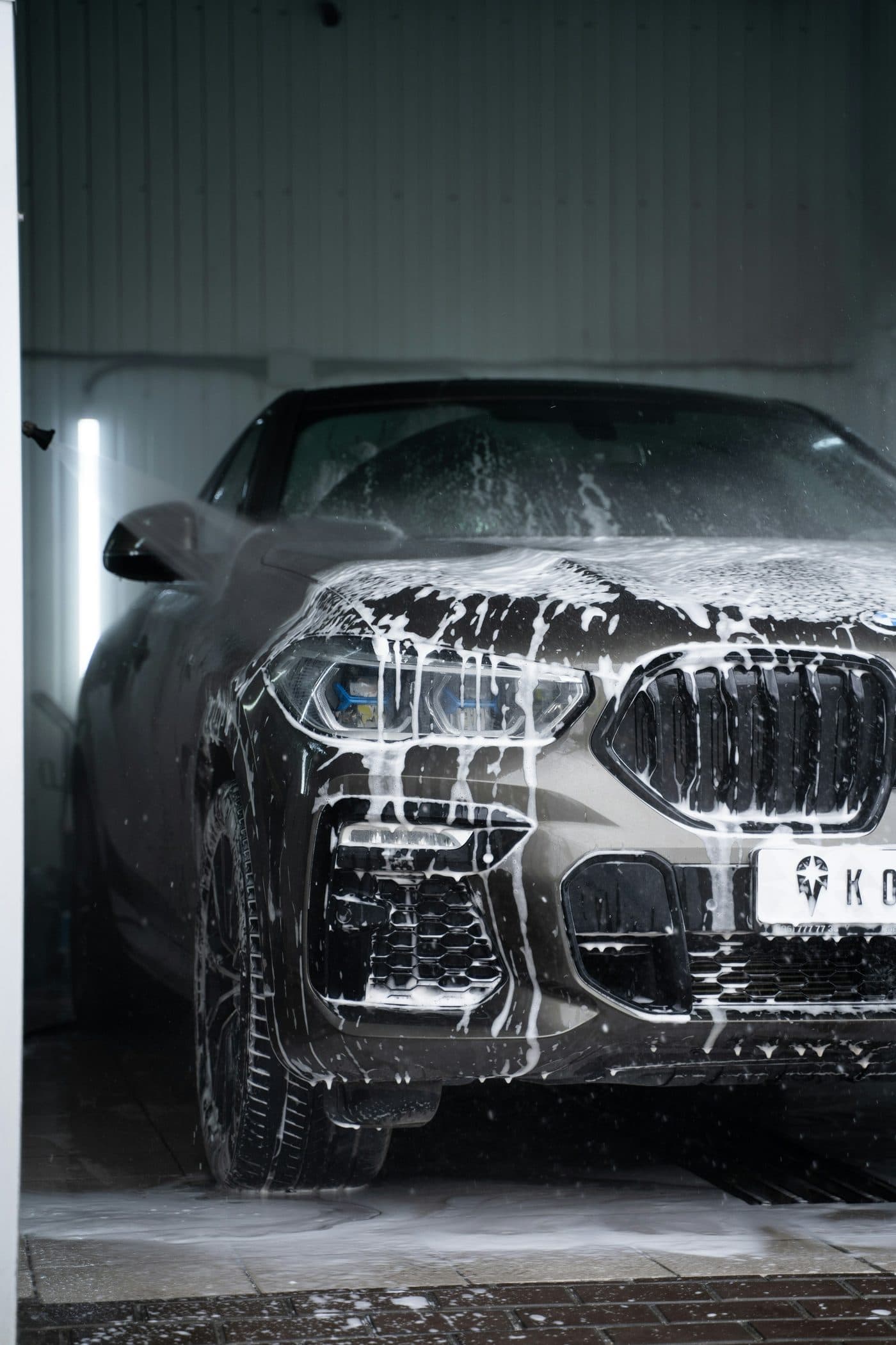 Car covered in snow foam during a wash
